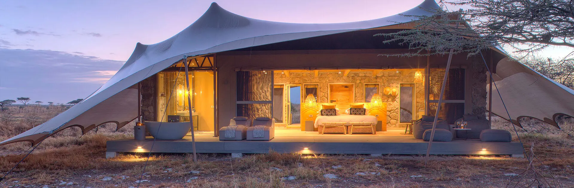 Best Luxury Lodges Serengeti 2026 — tented camp at sunset overlooking Serengeti plains
