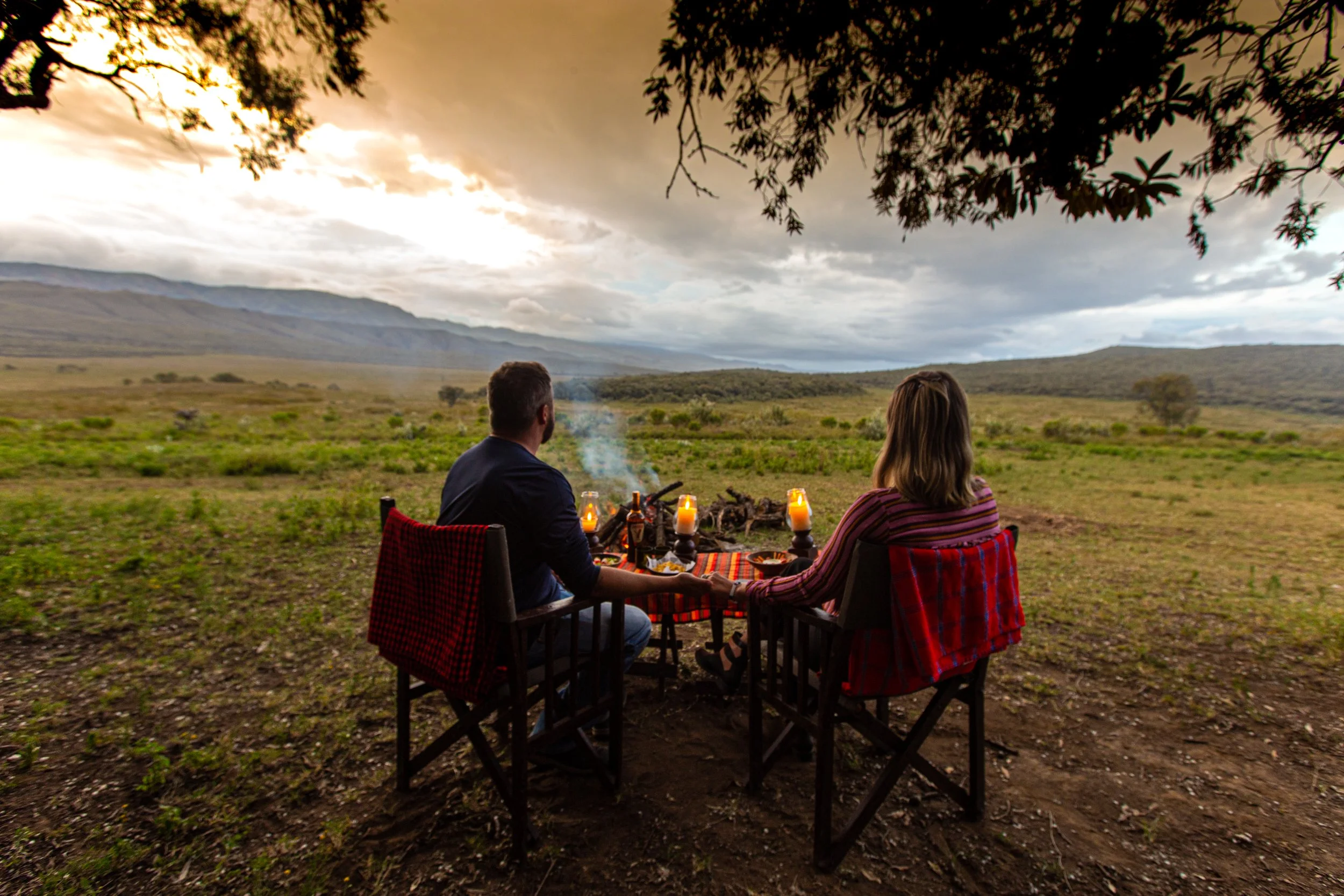 Romantic honeymoon couple enjoying private safari in Masai Mara